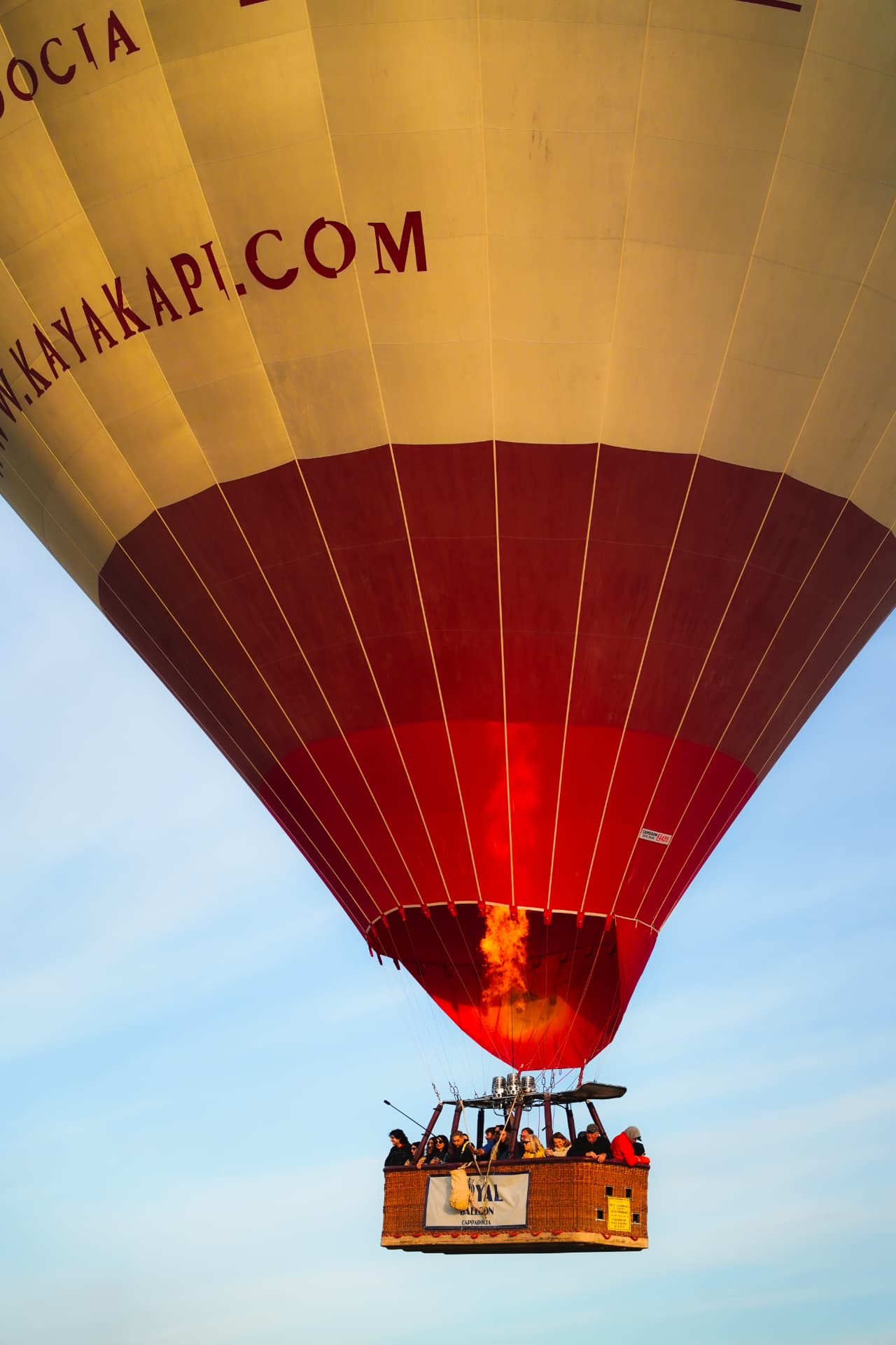Low angle of a red and gold hot air balloon in flight