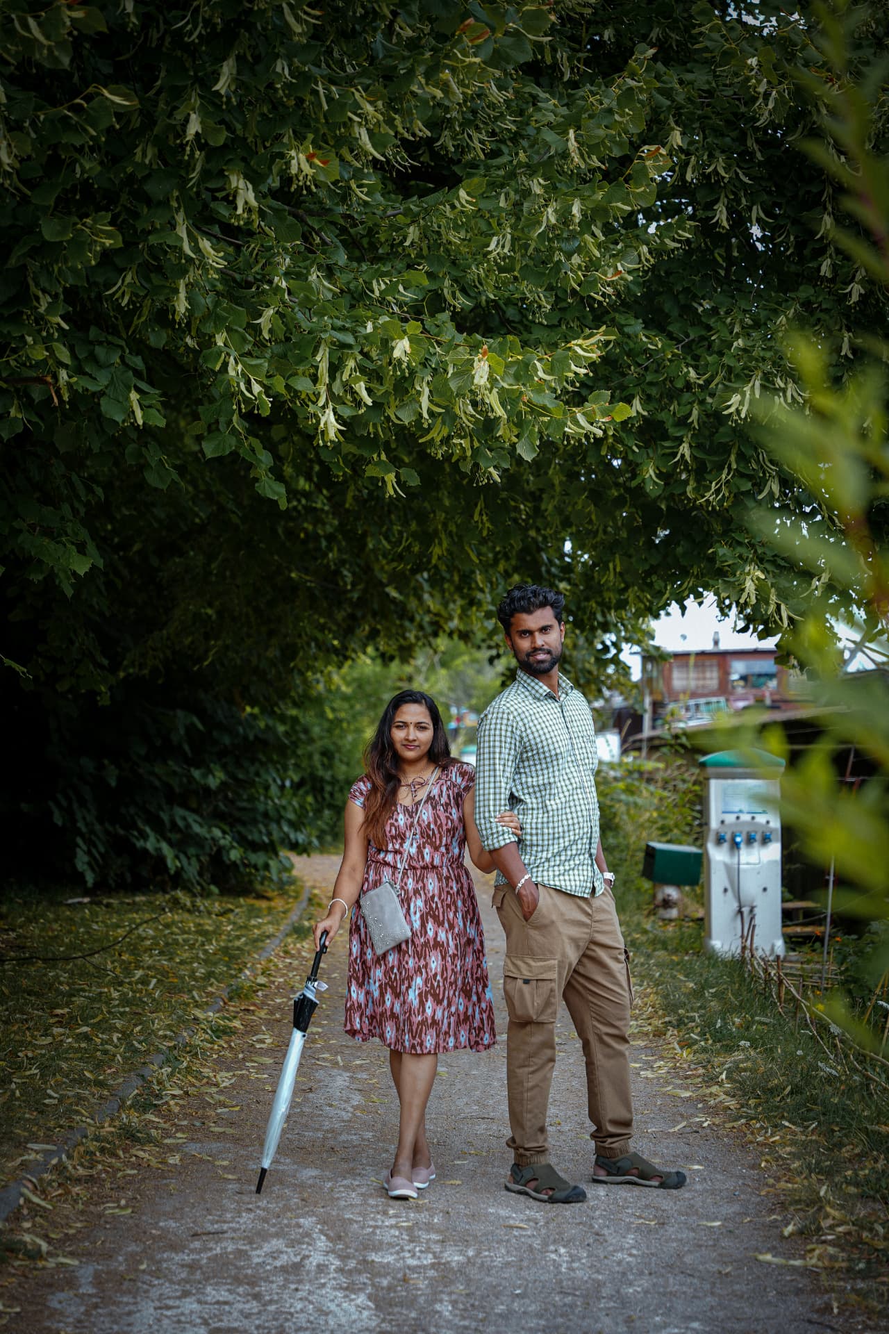 Couple portrait on a tree-lined canal path