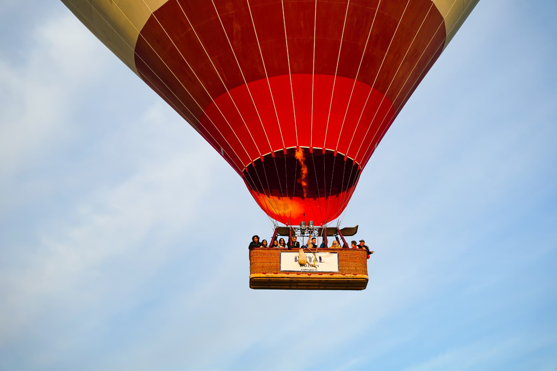 Hot air balloon burner firing against a blue sky in Cappadocia